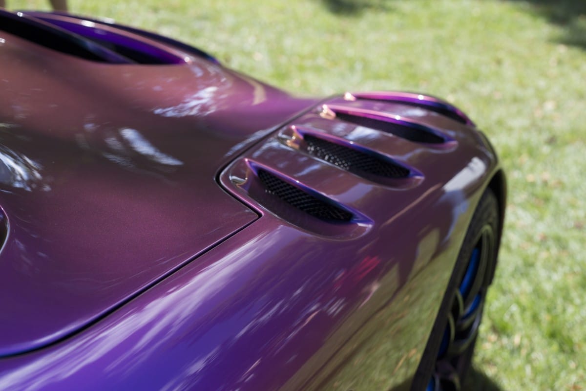 Detail of metallic purple sports car.  Illustrative image text waxing car.