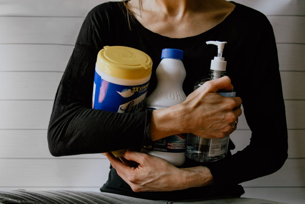 woman holding cleaning products. 