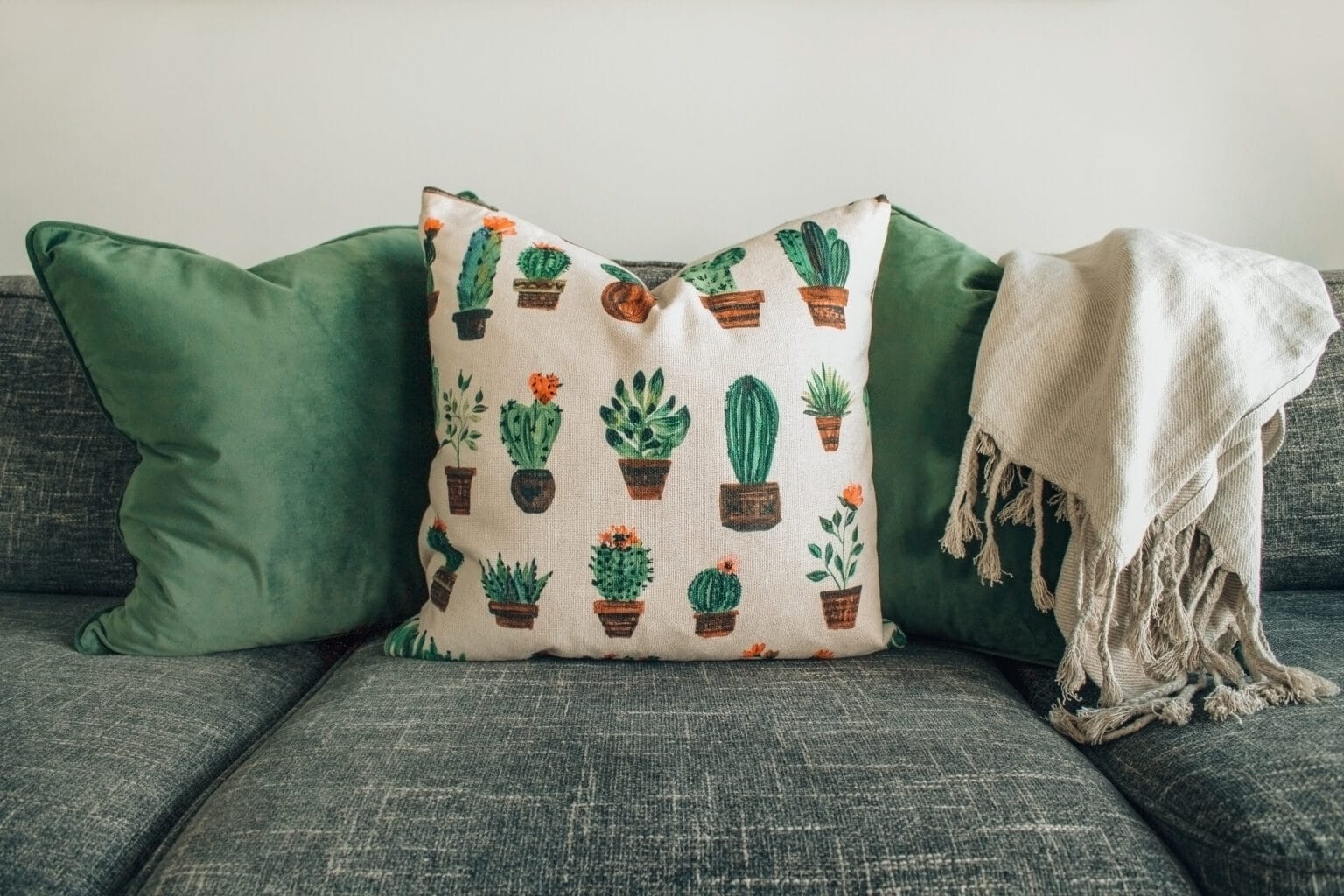 Green cushions on a gray sofa. 