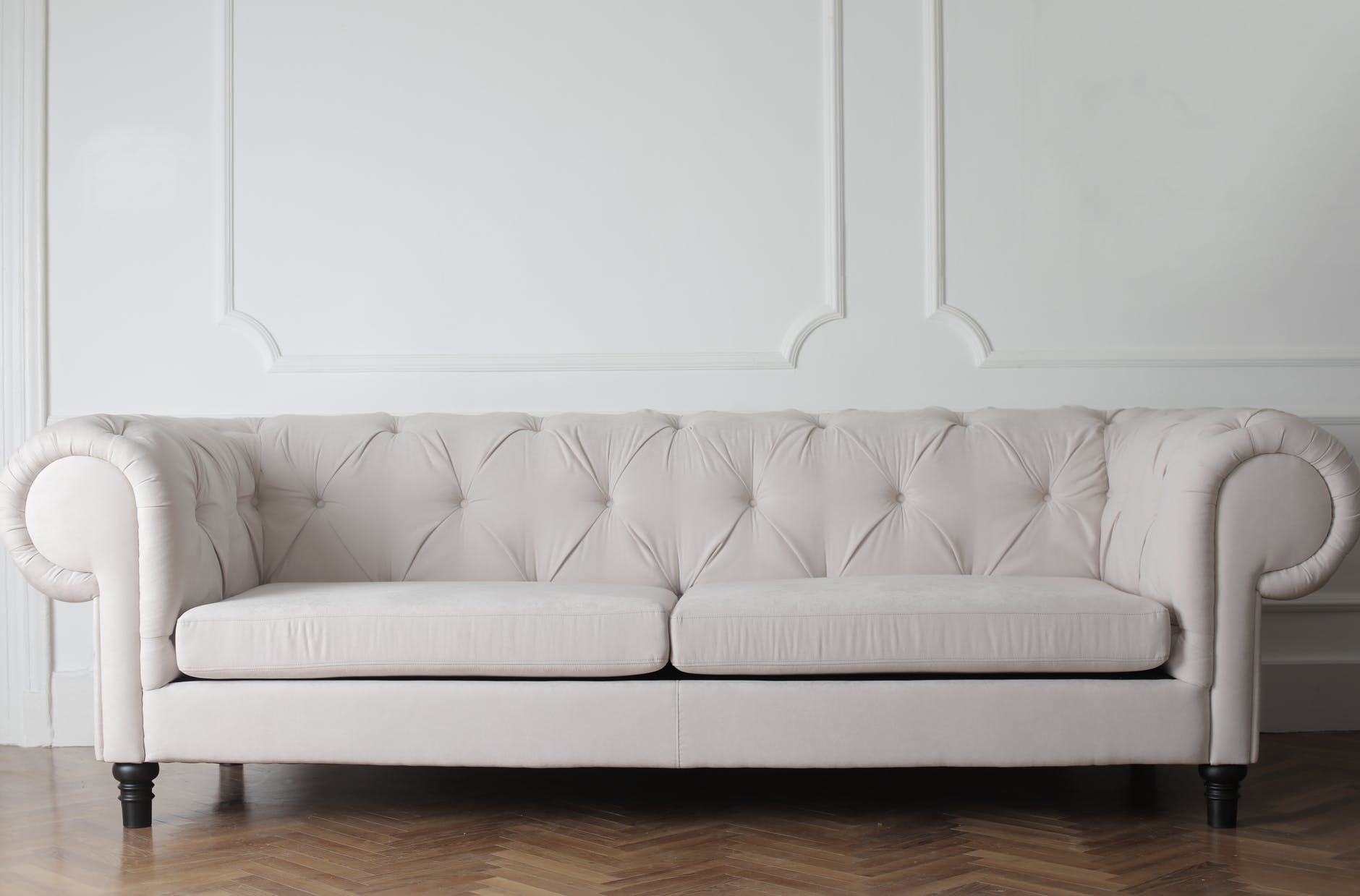 Sofá branco em destaque. Imagem ilustrativa do texto sobre como deixar o sofá cheiroso.